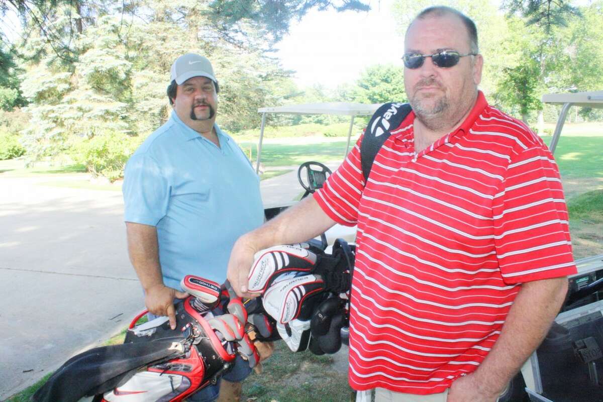 golf trip: Steve Williams, front, and Jerry Bella of Indiana prepare for a round of golf at Marquette Trails Country Club. (Star/John Raffel)