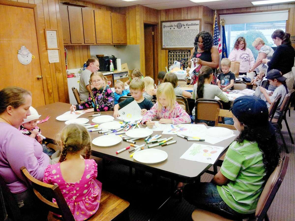 CRAFT TIME: Children and adults participate in a craft at Pathfinder Community Library during its Story Hour, which was held throughout July. (Courtesy photo)