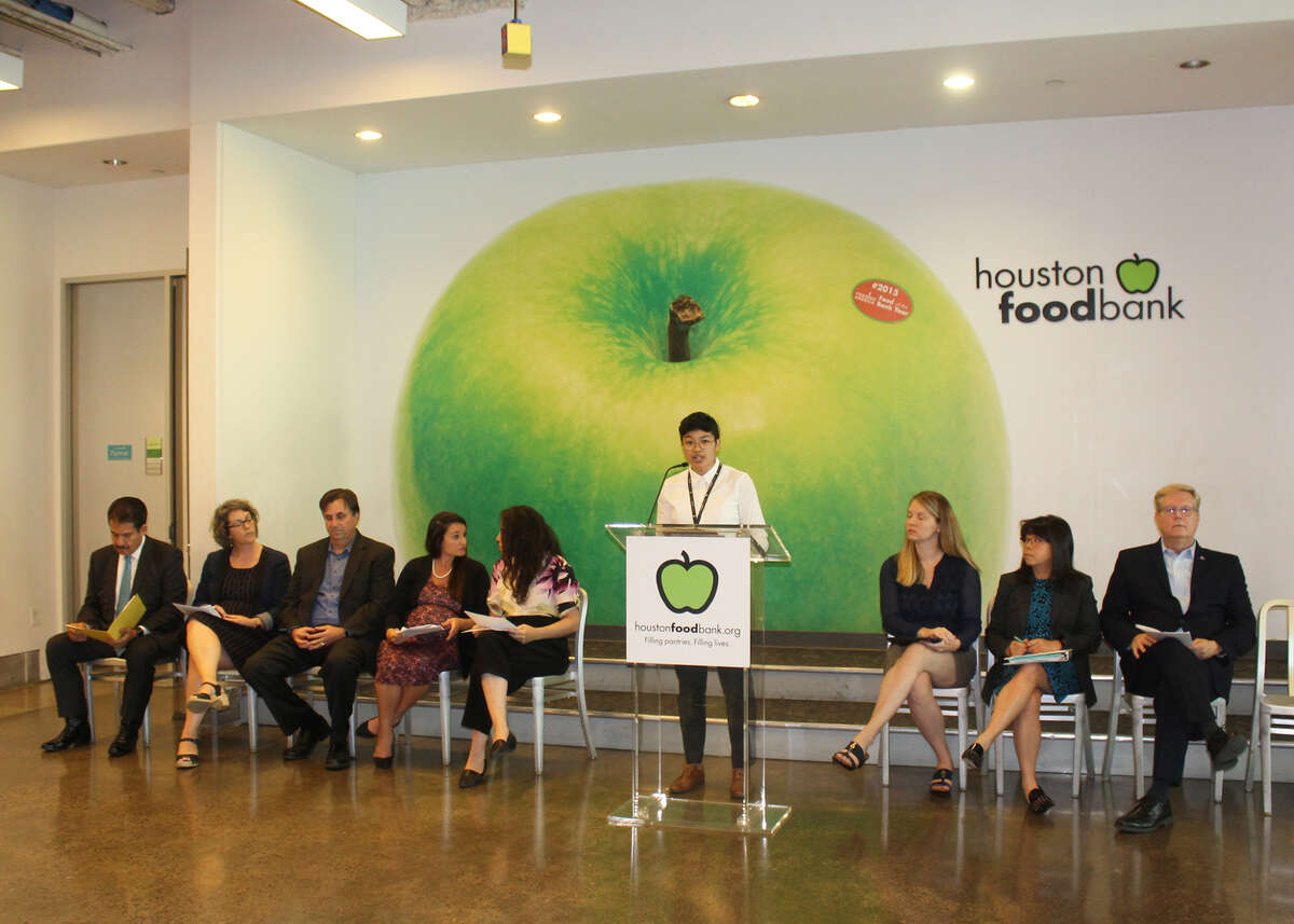 Melanie Pang, government relations officer for the Houston Food Bank, welcoming guests at a panel on the Trump administration's new "public charge" rule on Friday at the Houston Food Bank.