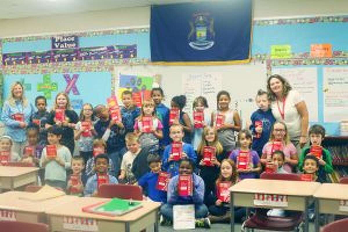 DICTIONARIES: Students from Melissa Johnson’s third-grade class were among many third-graders at Baldwin Community Schools who received dictionaries from the Baldwin Lions Club.