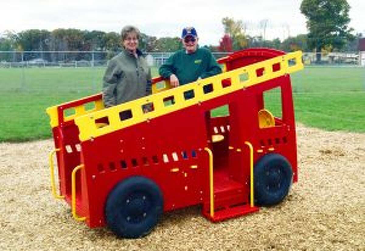EQUIPMENT: Sauble Township Trustee and Deputy Clerk Gail Raad and Sauble Township Supervisor Bill Gillard show the new playground equipment, Freddy the Fire Truck.