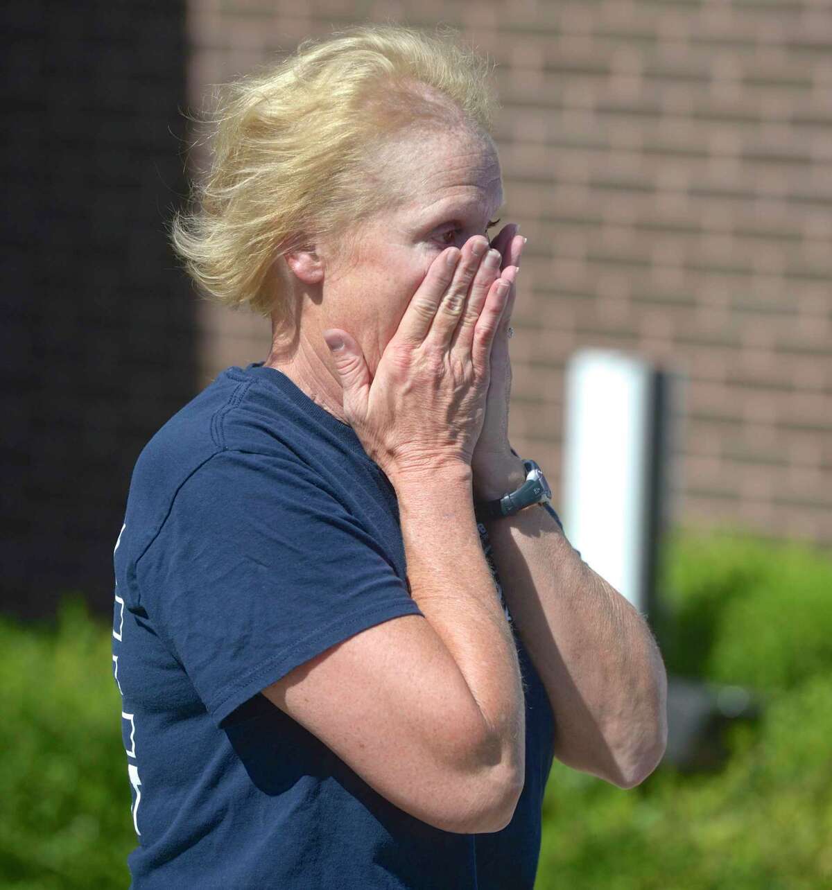Lieutenant Lorinda Arconti wipes away tears during a flag ceremony to mark her retirement after 32 years with the Danbury Fire Department. Arconti was the first female firefighter and the first female Lieutenant.
