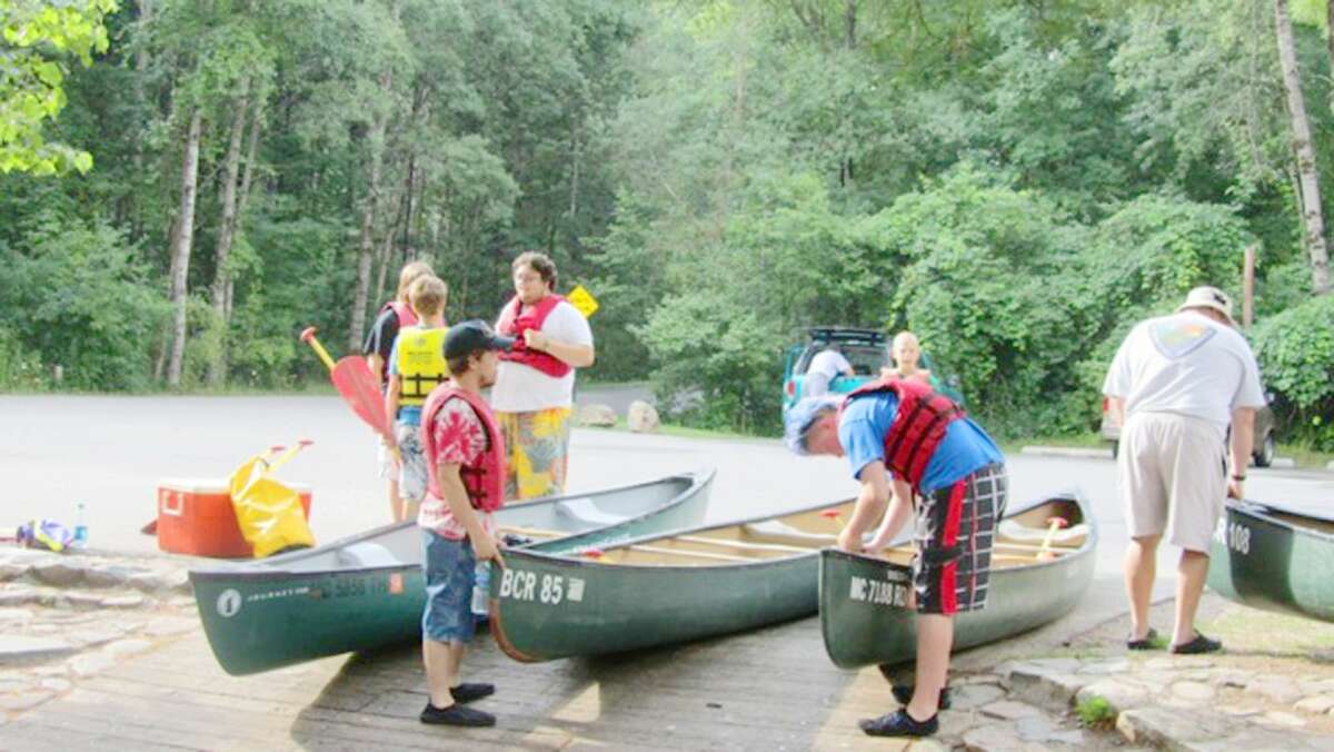 GEARING UP: Boy Scouts from Muskegon’s Troop 1053 assemble on Aug. 1 to clean refuse from the Pere Marquette River. It was the 49th annual cleanup. (Courtesy photo/Kim Engebretsen)