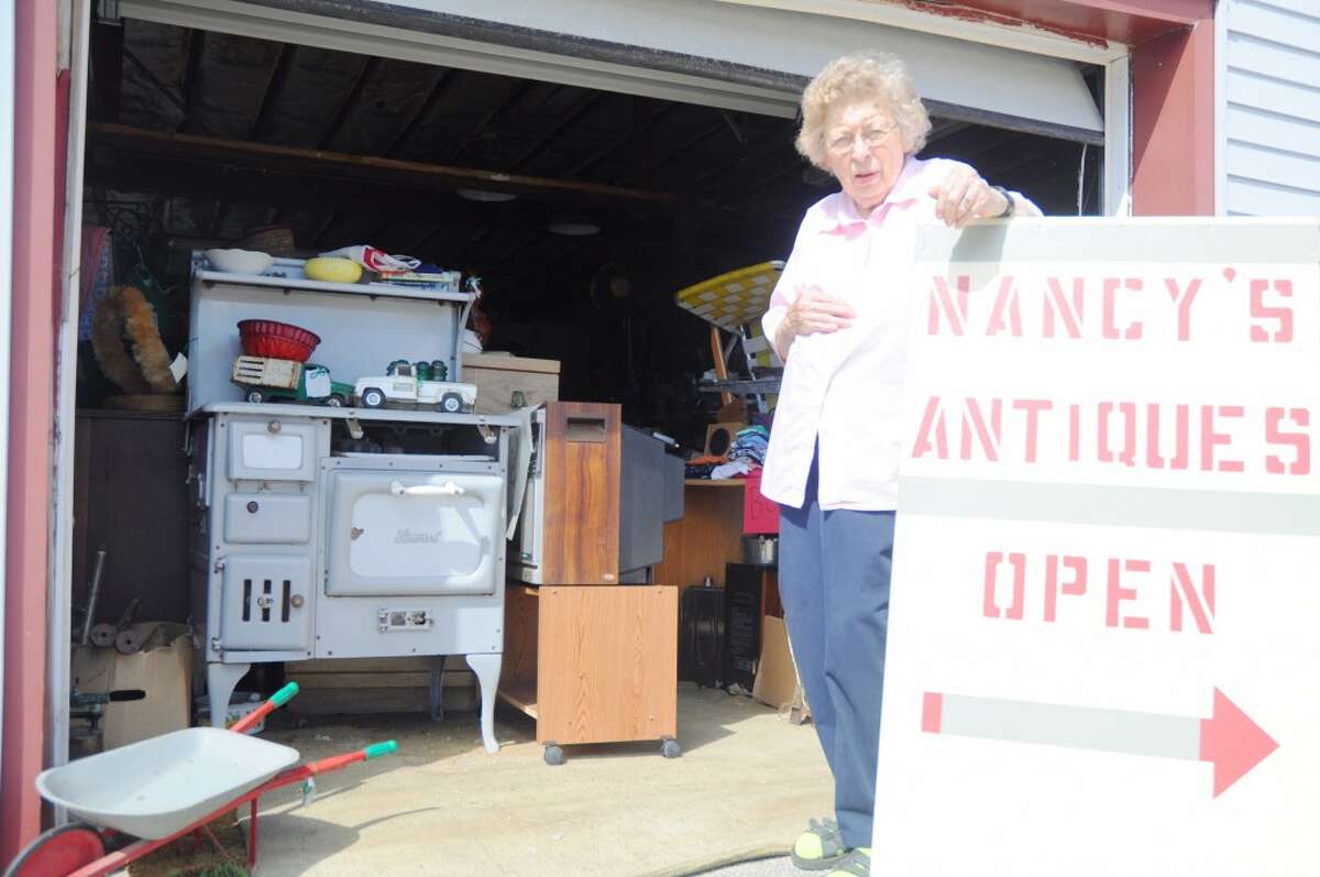 COMING TO AN END: Nancy Vandenberge stands outside of her Baldwin shop, Nancy’s Antiques. After six years in business, Vandenberge plans to close the business next month. (Star photo/Kyle Leppek)