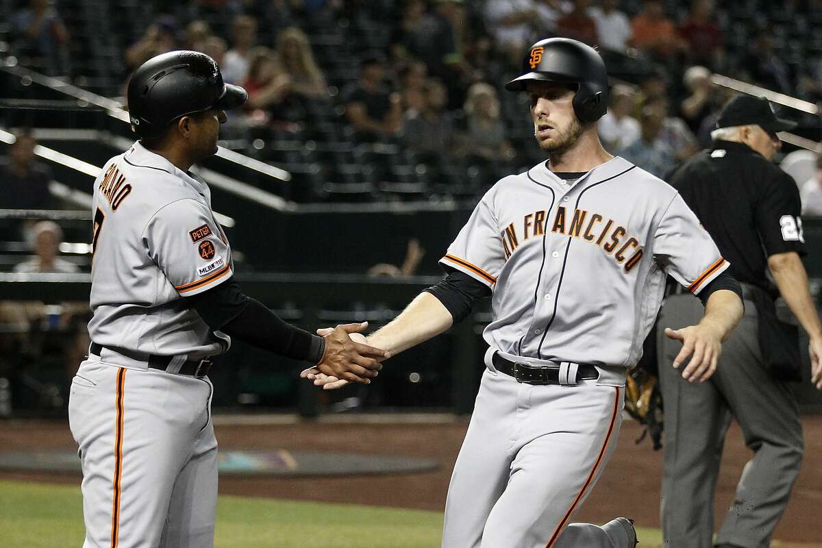 San Francisco Giants left fielder Barry Bonds (left) stands next