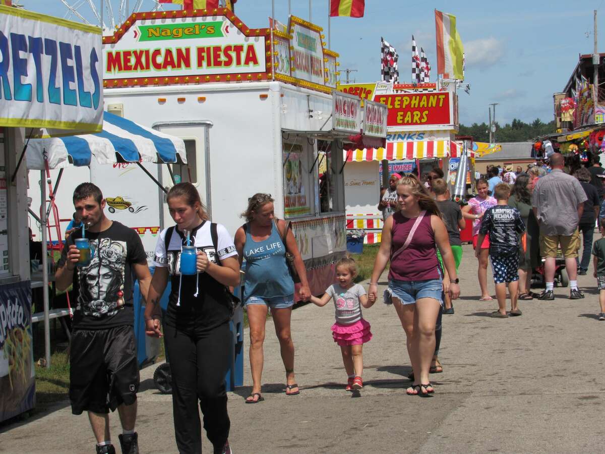 Visitors to the Midland County Fair on Saturday, Aug. 17, 2019 enjoy rides, games, food and events.