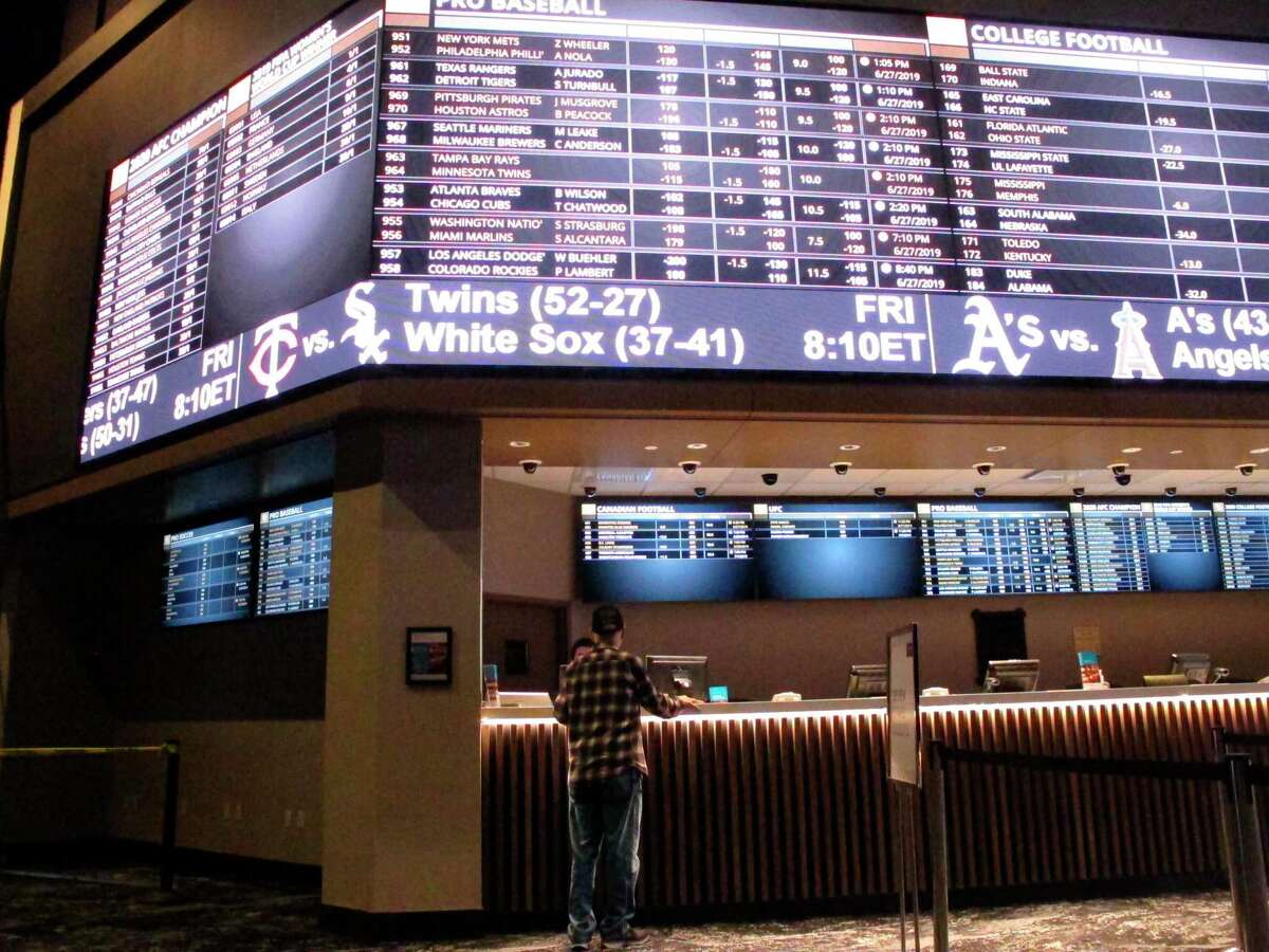 A customer ponders the odds at the sportsbook at Bally's casino in Atlantic City, N.J.