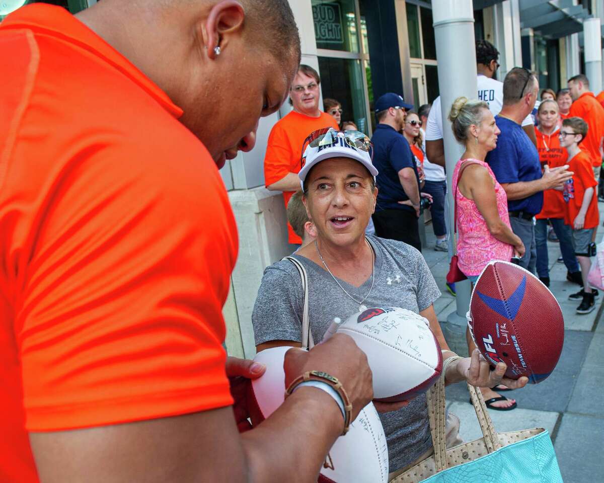 Albany lineman Brandon Sesay signs an autograph for Colton Cramer, of Schenectady at a block party to celebrate the team’s Arena Bowl win in 2019. Now Sesay is with the new Empire and is set to make his debut in the National Arena League playoffs.
