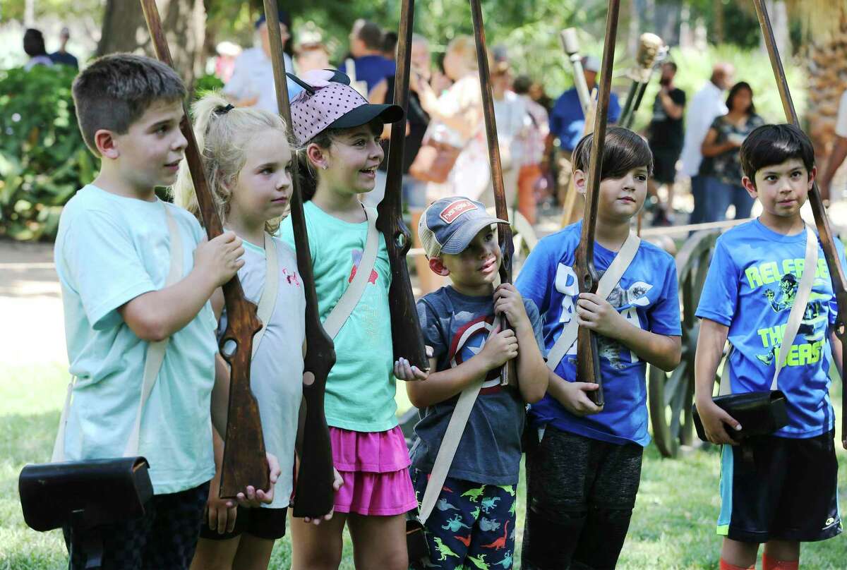 Several children seemingly relish the role of Alamo defenders during a demonstration as the Alamo celebrates Davy Crockett's birthday with frontier demonstrations on the grounds, rubber-band rifle shooting and living historians that include a portrayal of Crockett himself on Saturday, Aug. 17, 2019. Activities started in the morning and went into the evening with a discussion about Crockett and then a showing of "Davy Crockett: King of the Wild Frontier" at 8 p.m. outdoors in the Alamo Gardens. (Kin Man Hui/San Antonio Express-News)
