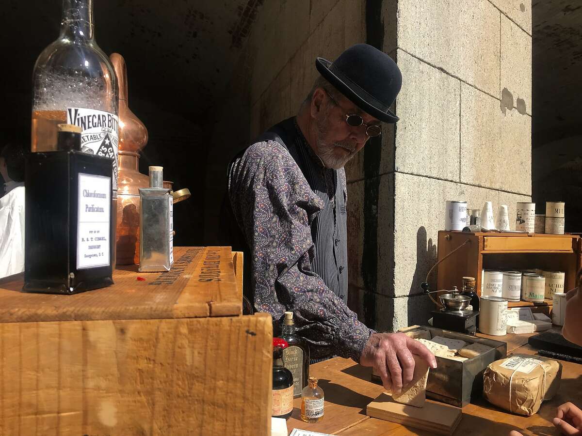 Wayne Mabie, 77, of San Martin, shows visitors of the 2019 Civil War reenactment at Fort Point in San Francisco how durable hardtack was for soldiers who consumed the tough, cracker-like food during the war.