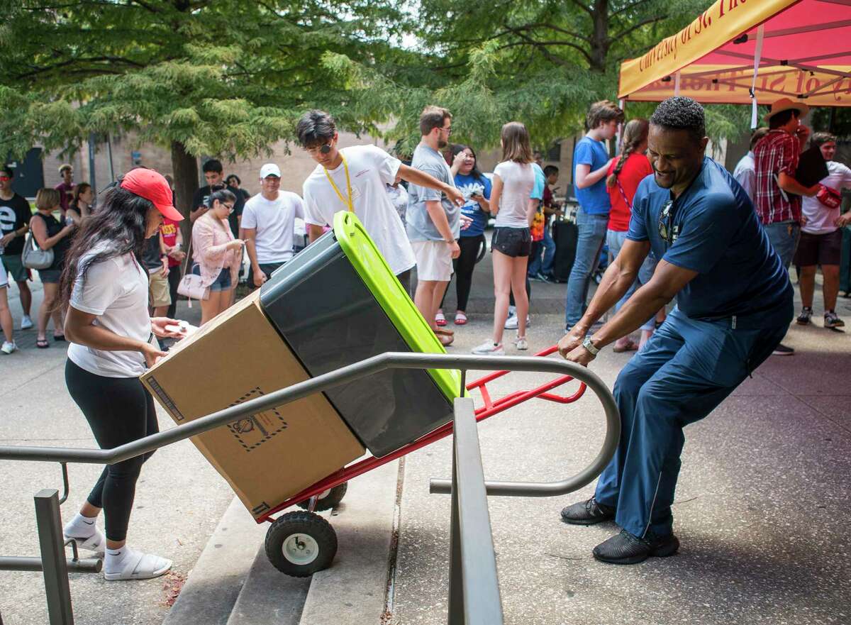 Students line up outside of Guinan Residence Hall at the University of St. Thomas during move-in day in Houston, Wednesday, Aug. 14, 2019.