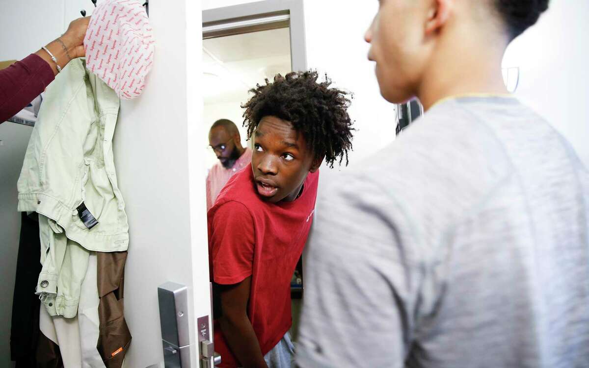 Marc Wilson listens to last minute advice from his brother, Malik, as they move Marc into his University of Houston dorm on Saturday, Aug. 17, 2019 in Houston. Marc's brother attends Morehouse College.