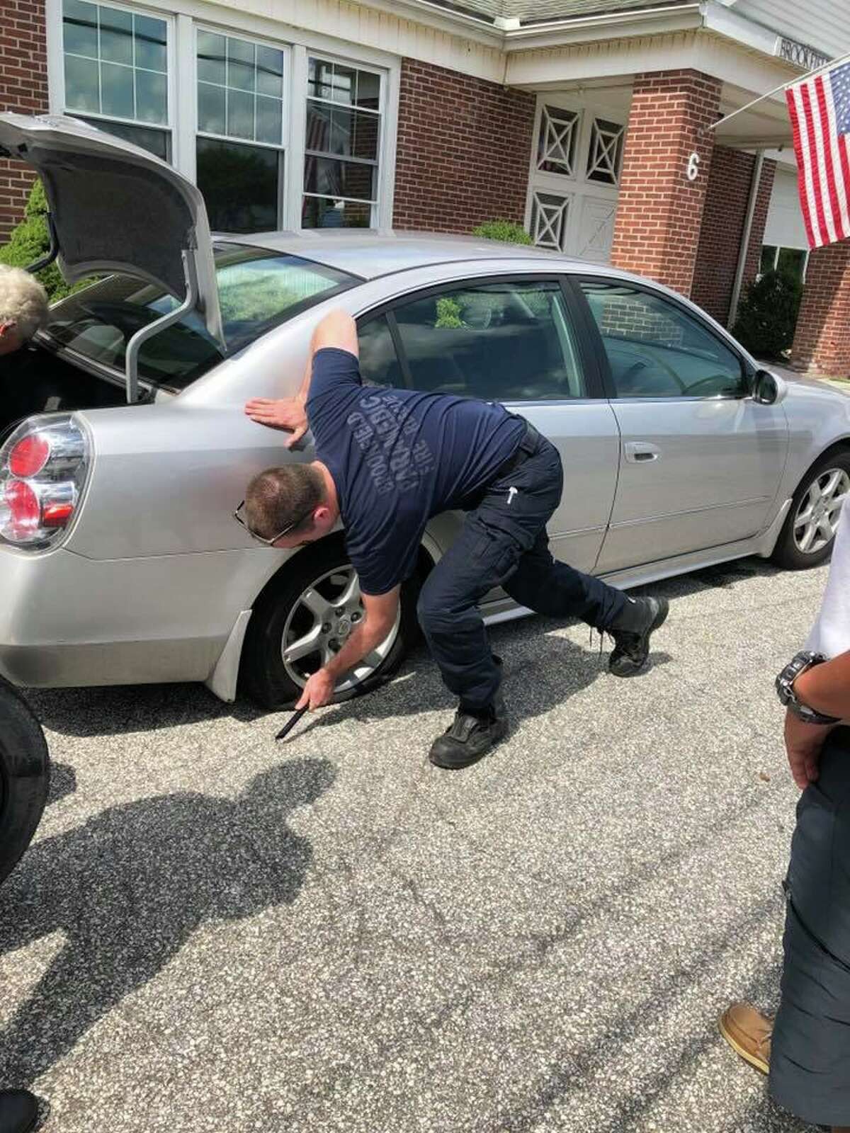 A group of first responders with Brookfield Volunteer Fire Company helped a senior citizen get back on the road when she got a flat tire on Saturday, Aug. 17, 2019.