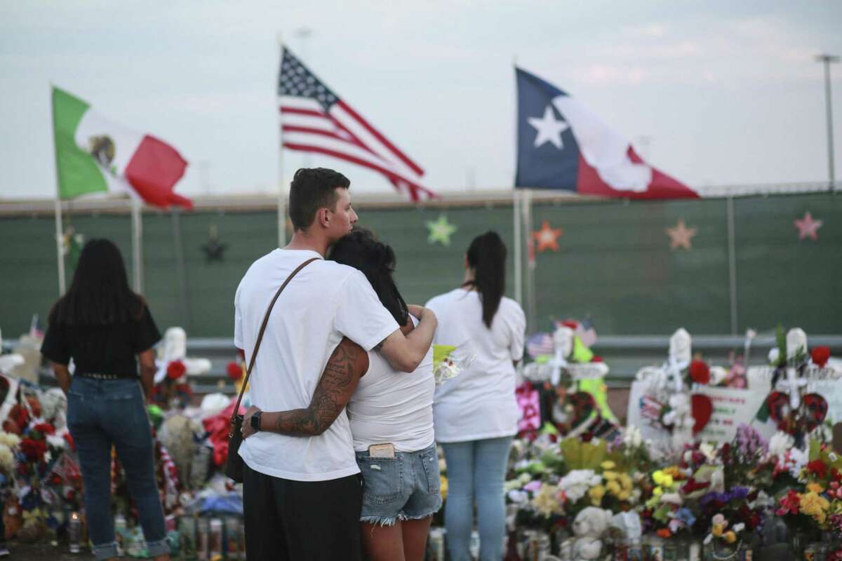 EL PASO, TX - AUGUST 15: People gather at a makeshift memorial honoring victims outside Walmart August 15, 2019 in El Paso, Texas. 22 people were killed in the Walmart during a mass shooting on August 3rd. A 21-year-old white male suspect remains in custody in El Paso which sits along the U.S.-Mexico border. (Photo by Sandy Huffaker/Getty Images)