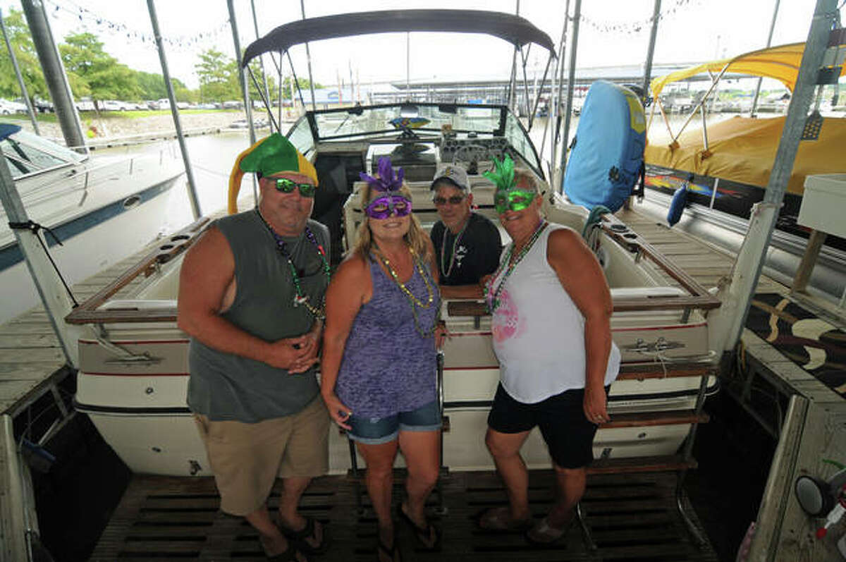 Kevin Lamble, left, and his shipmates don Mardi Gras apparel before leaving Alton Marina on Saturday for the Blessing of the Fleet.