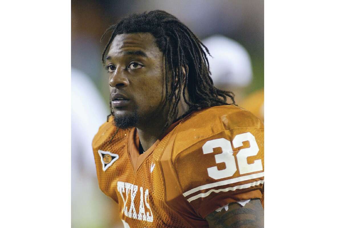 FILE - In this Nov. 6, 2004 file photo Texas running back Cedric Benson is shown in the bench area during the fourth quarter of his team's 56-35 victory over Oklahoma State in Austin, Texas. Benson, one of the most prolific rushers in NCAA and University of Texas history, has died in a motorcycle accident in Texas, Saturday, Aug. 17, 2019. He was 36. (AP Photo/Harry Cabluck, file)