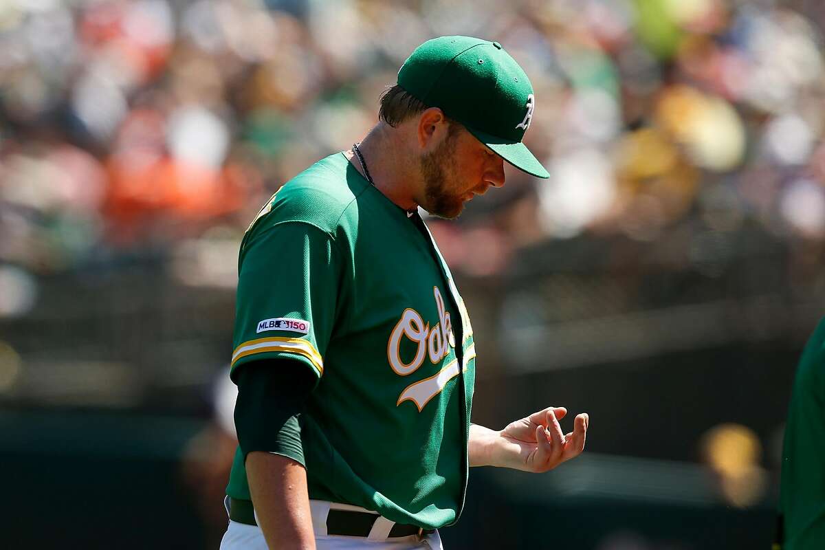 OAKLAND, CALIFORNIA - AUGUST 18: Starting pitcher Brett Anderson #30 of the Oakland Athletics looks at his hand as he leaves the game against the Houston Astros in the top of the sixth inning at Ring Central Coliseum on August 18, 2019 in Oakland, California. (Photo by Lachlan Cunningham/Getty Images)