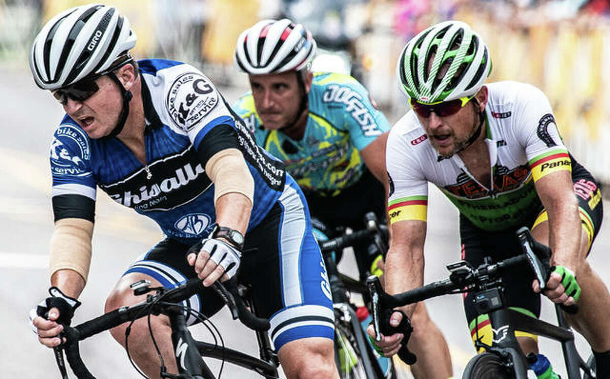 Riders Saturday keep close on a sharp turn during the Edwardsville Rotary Criterium Festival.
