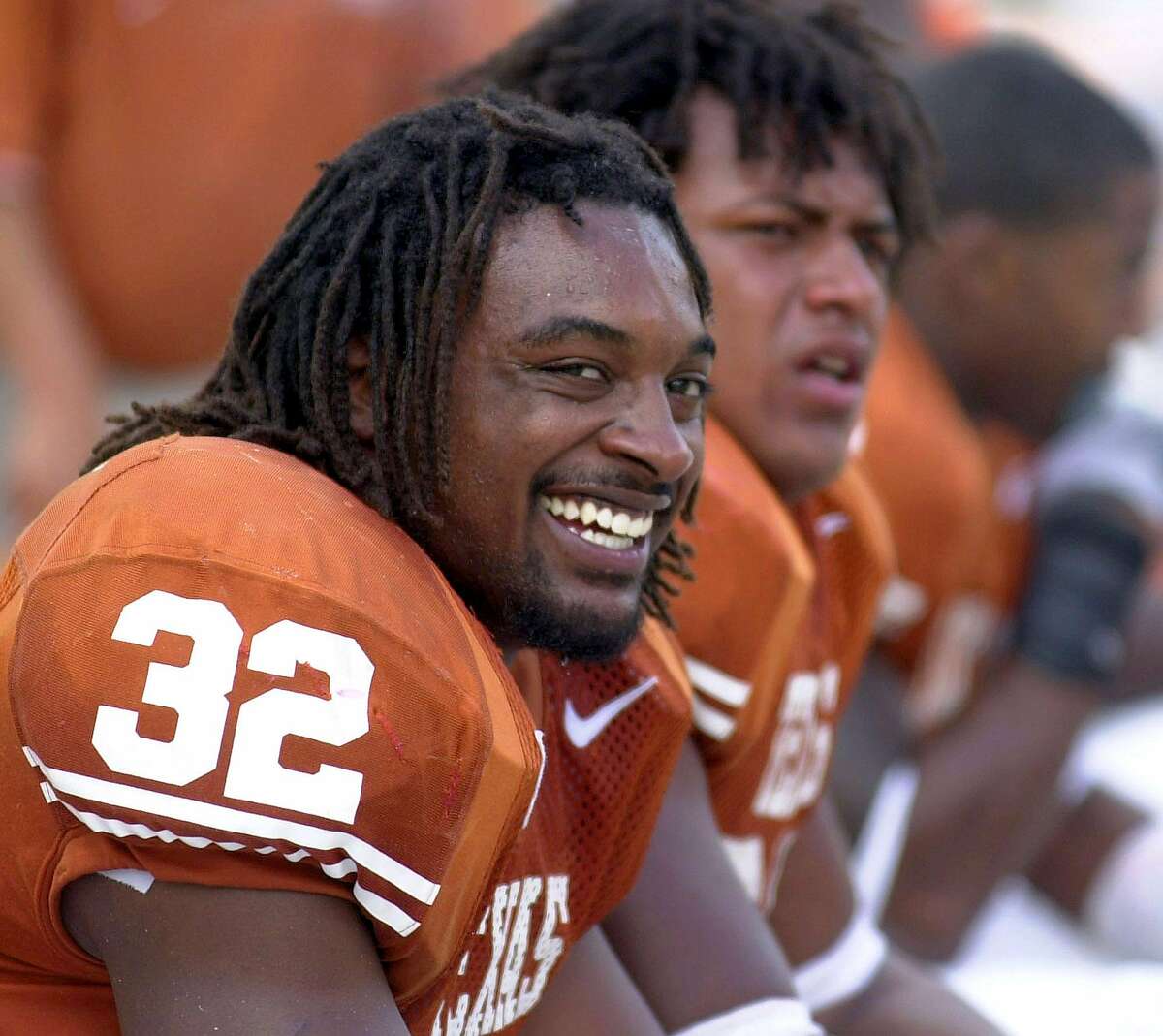 Texas' Cedric Benson (32) is all smiles as he sits on the bench after scoring a touchdown against Nebraksa Saturday Nov 1, 2003 at Texas Memorial Stadium in Austin,Tx. Texas went on to defeat Nebraska 31-7. PHOTO BY EDWARD A. ORNELAS/STAFF