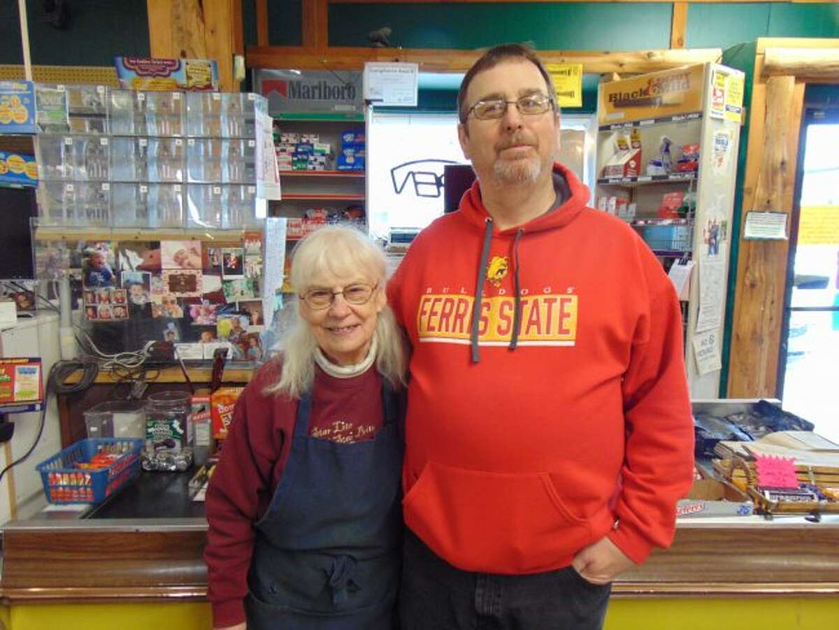 Betty Purchase, left, will continue serving people in the checkout line, and Scott Lucas, right, has spent some time making transitions as new owner of Luther Grocery. (Star photo/Shanna Avery)