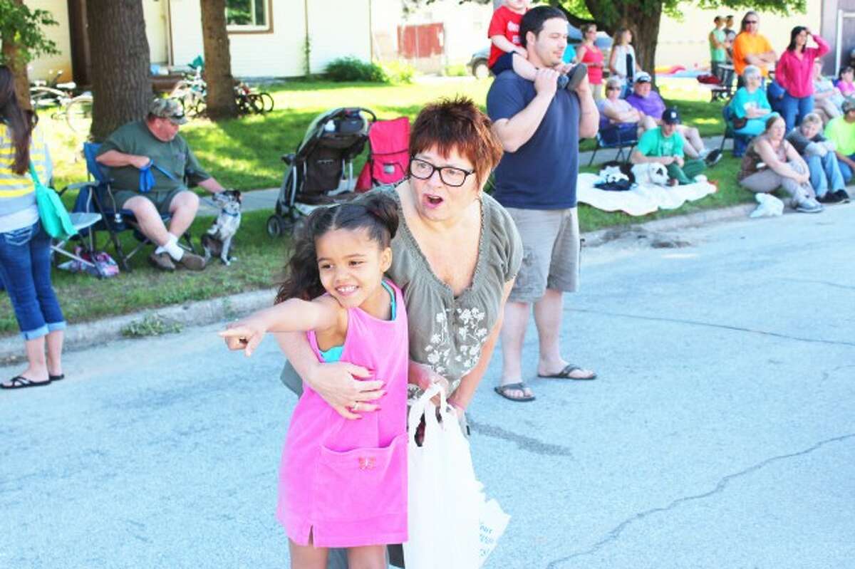 FAMILY FUN: Deb Abplanalp, of Rockford, and her 6-year-old granddaughter Raylee, enjoy the different floats on Saturday during the Luther Logging Days parade.