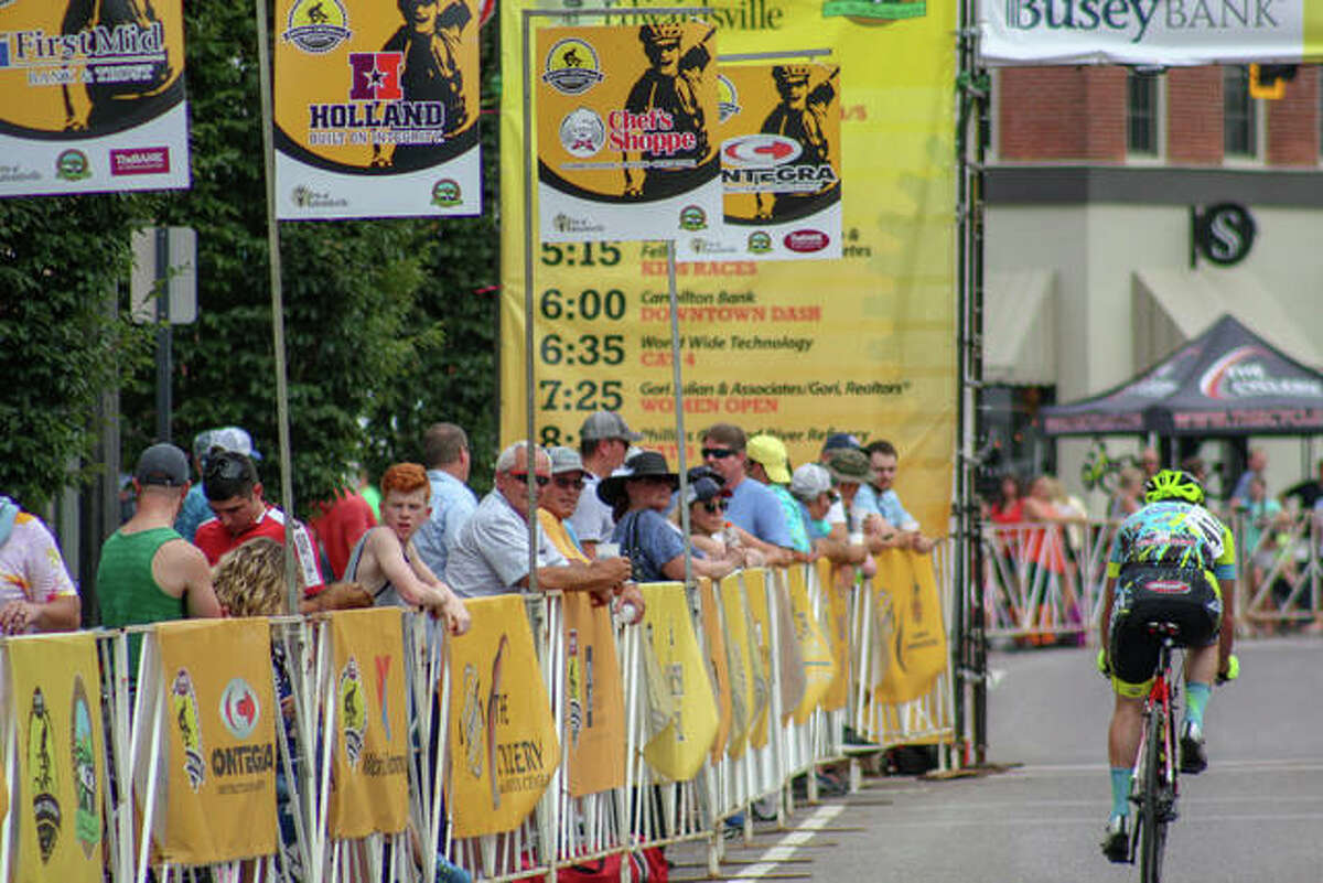 Fans watch a bicyclist in a race.