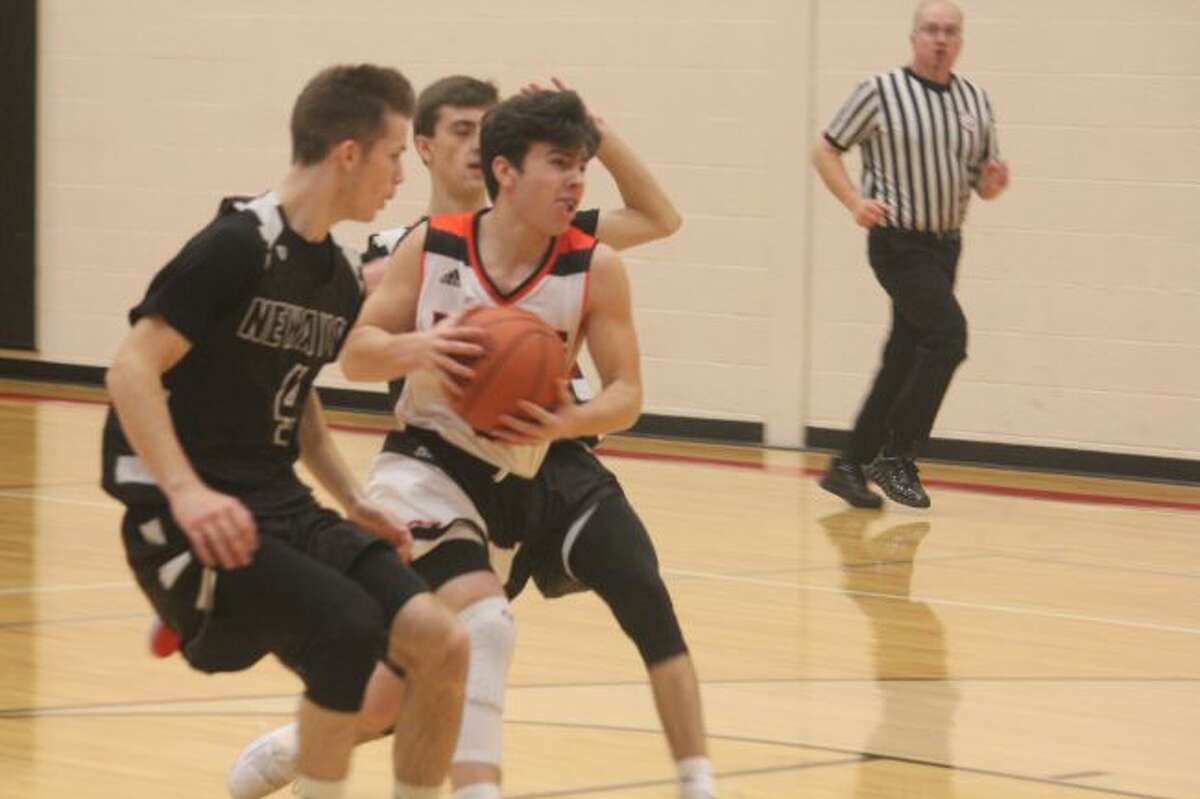 Zac Saez soars to the basket for Reed City.