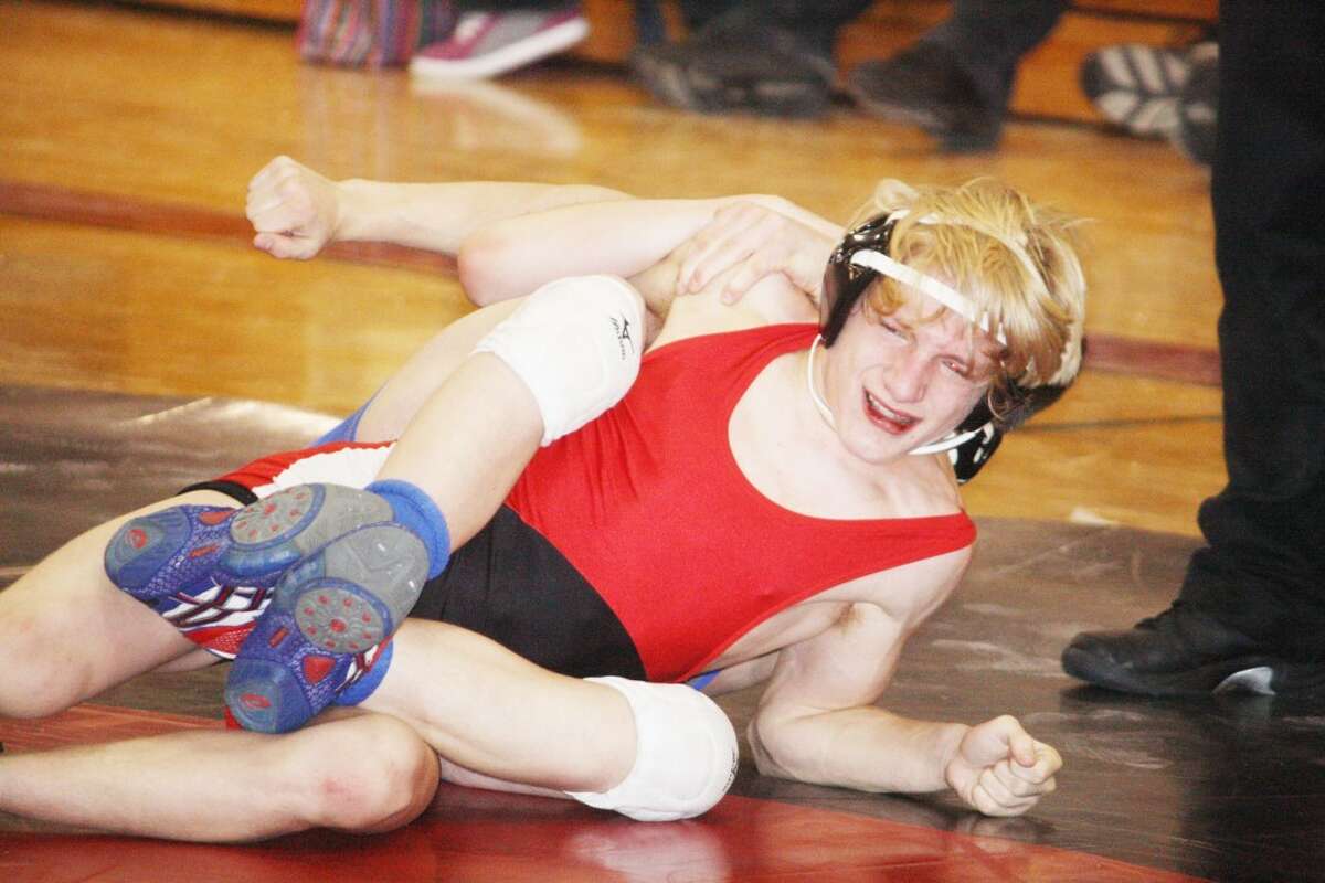 PIN HIM: Thayne Stieg of Reed City battles Sean Stenzel of Mason County Central in a 130-pound match Saturday at the Reed City Invitational.(Herald Review photo/John Raffel)