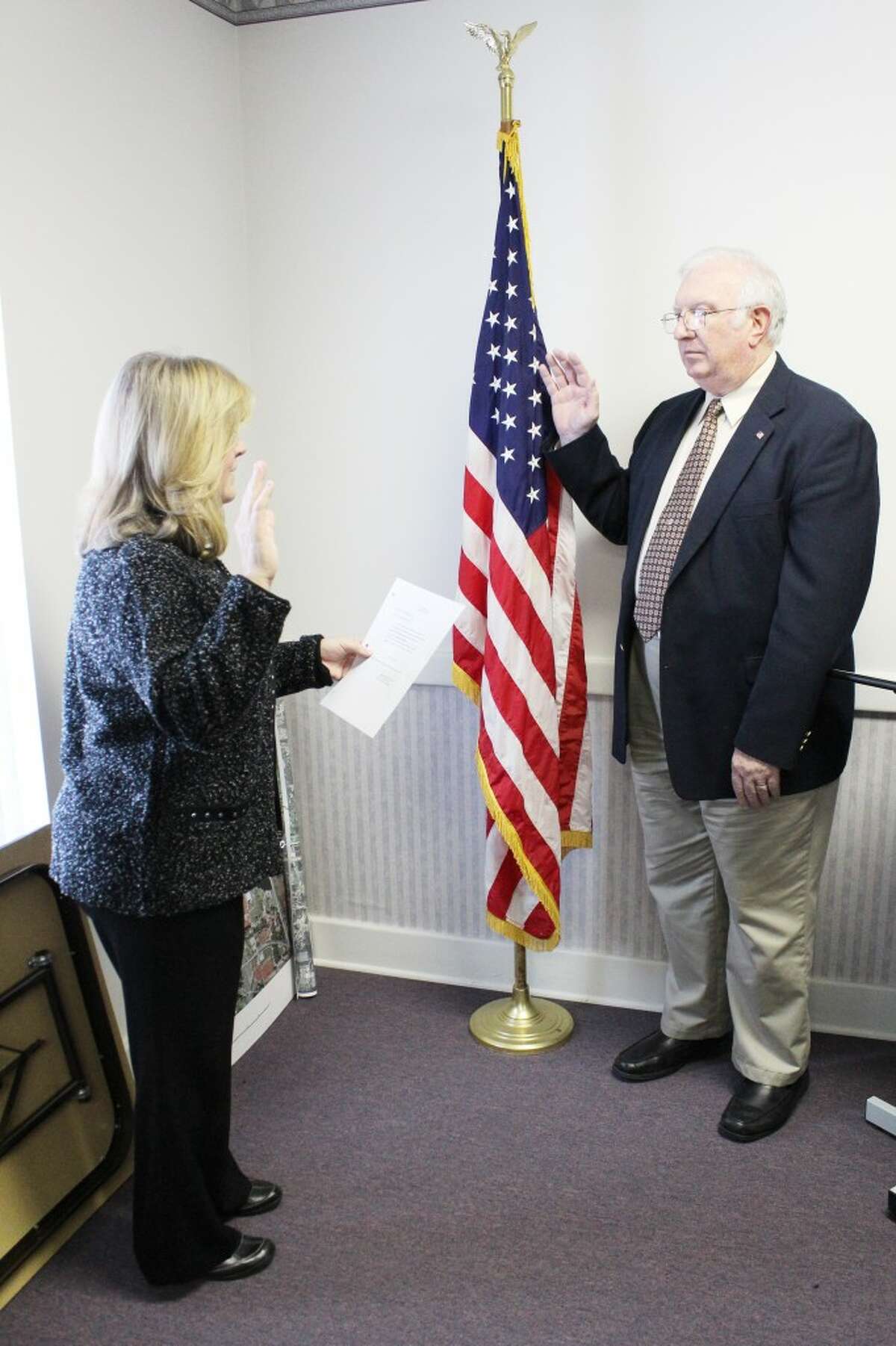 Prepared for the job: Ron Howell is sworn in as the interim city manager in Reed City. He is taking over after Ron Marek resigned in November.