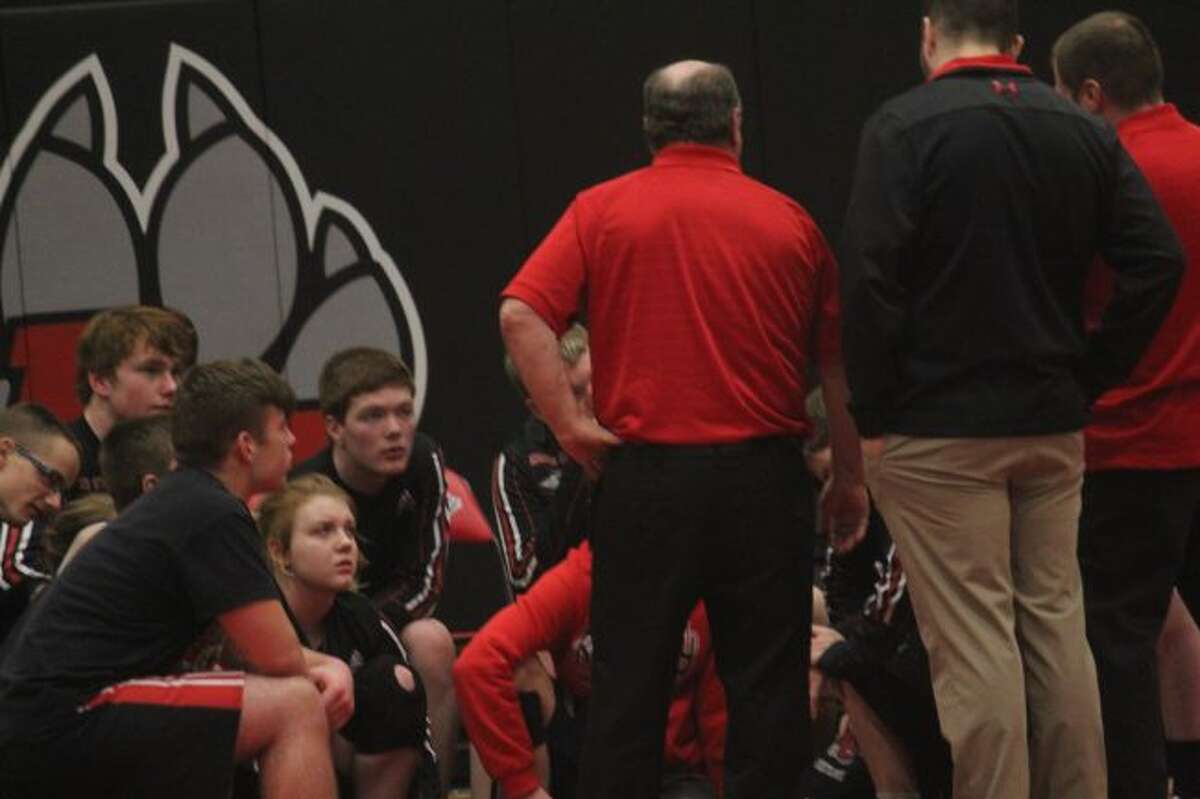 Reed City wrestlers talk with coach Roger Steig after a match.