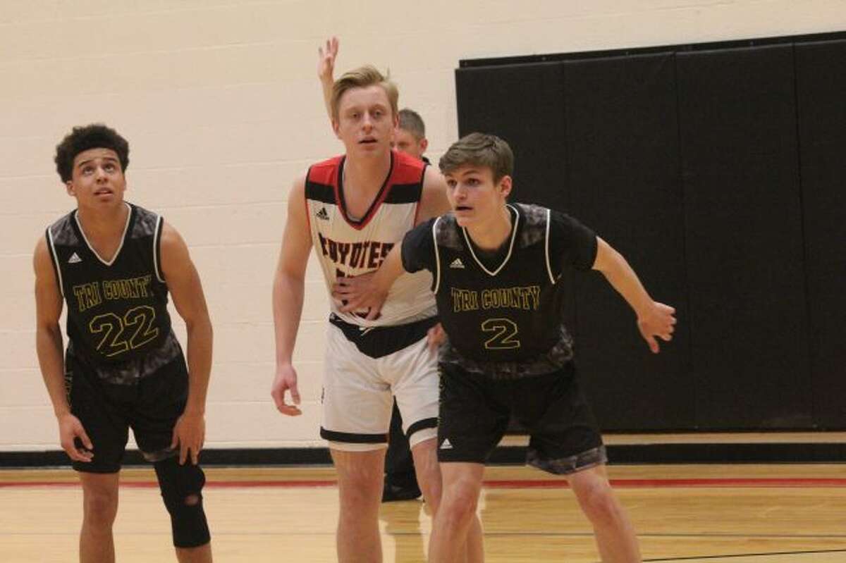 Preston Johnson (middle) gets ready for a rebound.