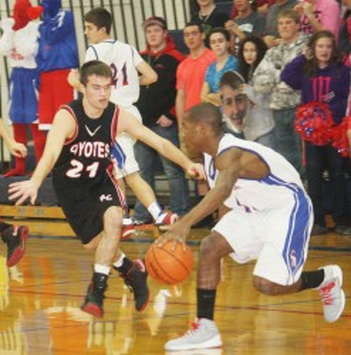ON GUARD: Reed City's Chad Samuels (left) sticks with Chippewa Hills' Qunnell Key during Thursday's basketball action. (Pioneer photo/John Raffel)