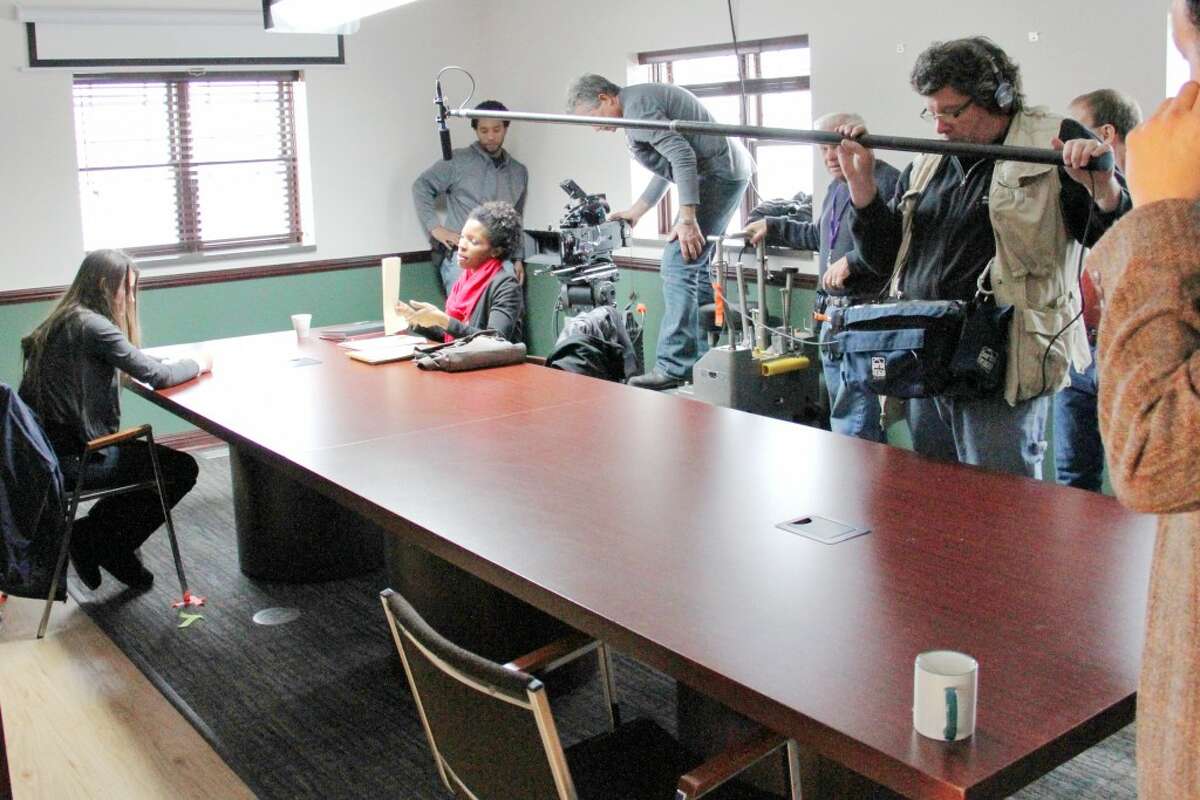 LIGHTS, CAMERA, ACTION: A movie production crew films an interrogation scene for “Chrysalis,” a short movie detailing the life of a 14-year-old girl making her way out of sex slavery. (Herald Review photo/Sarah Neubecker)
