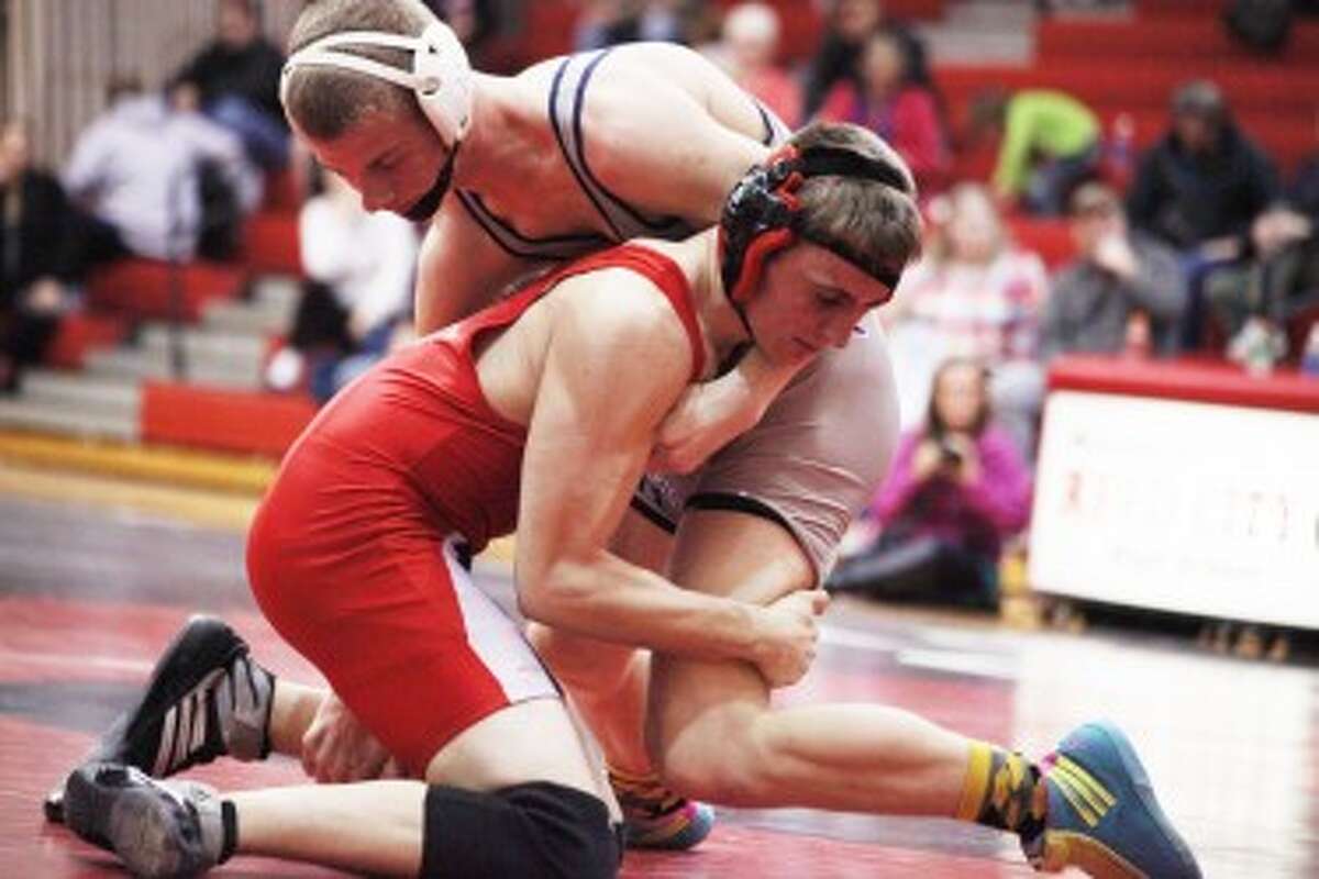 ALL OUT BATTLE: Big Rapids Jared Worden (top) looks to take down his opponent during Wednesday’s wrestling action. Worden went 2-0 for the Cardinals, who set the school record for dual wins in a season. (Pioneer photo/Martin Slagter)