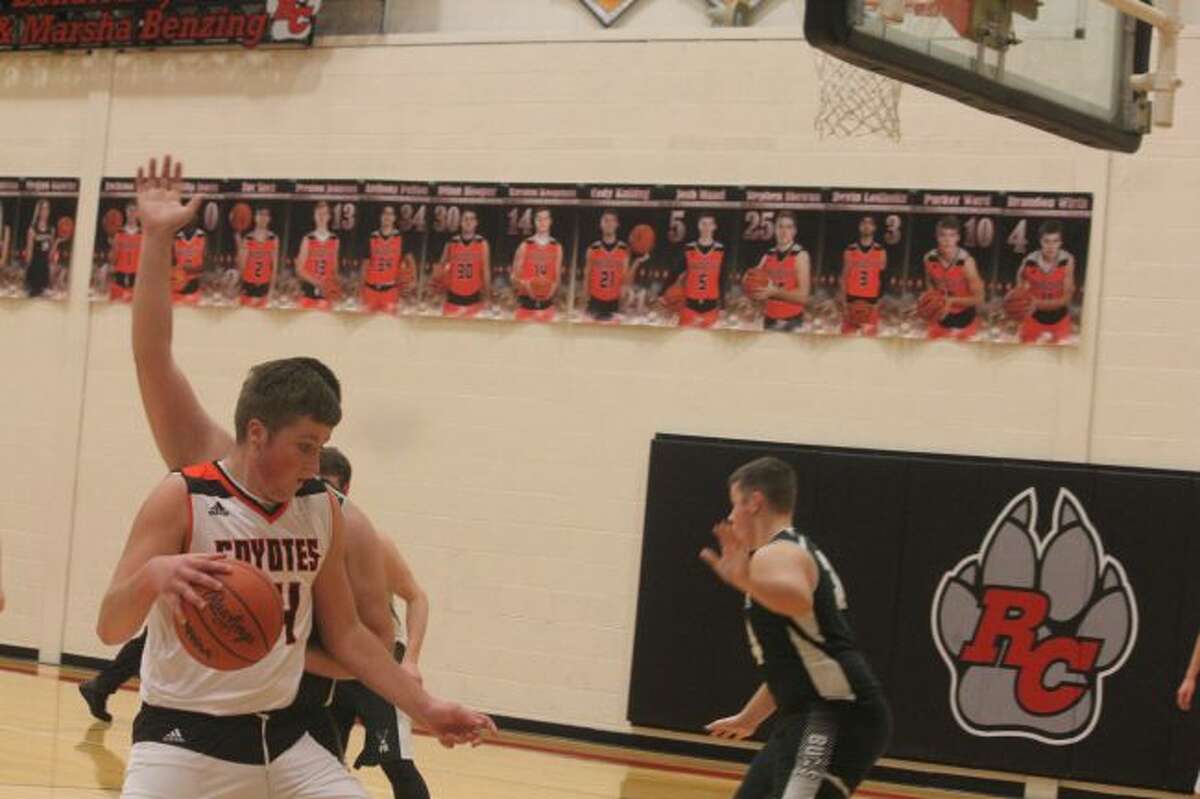 Karsten Koopman (left) heads to the basket.