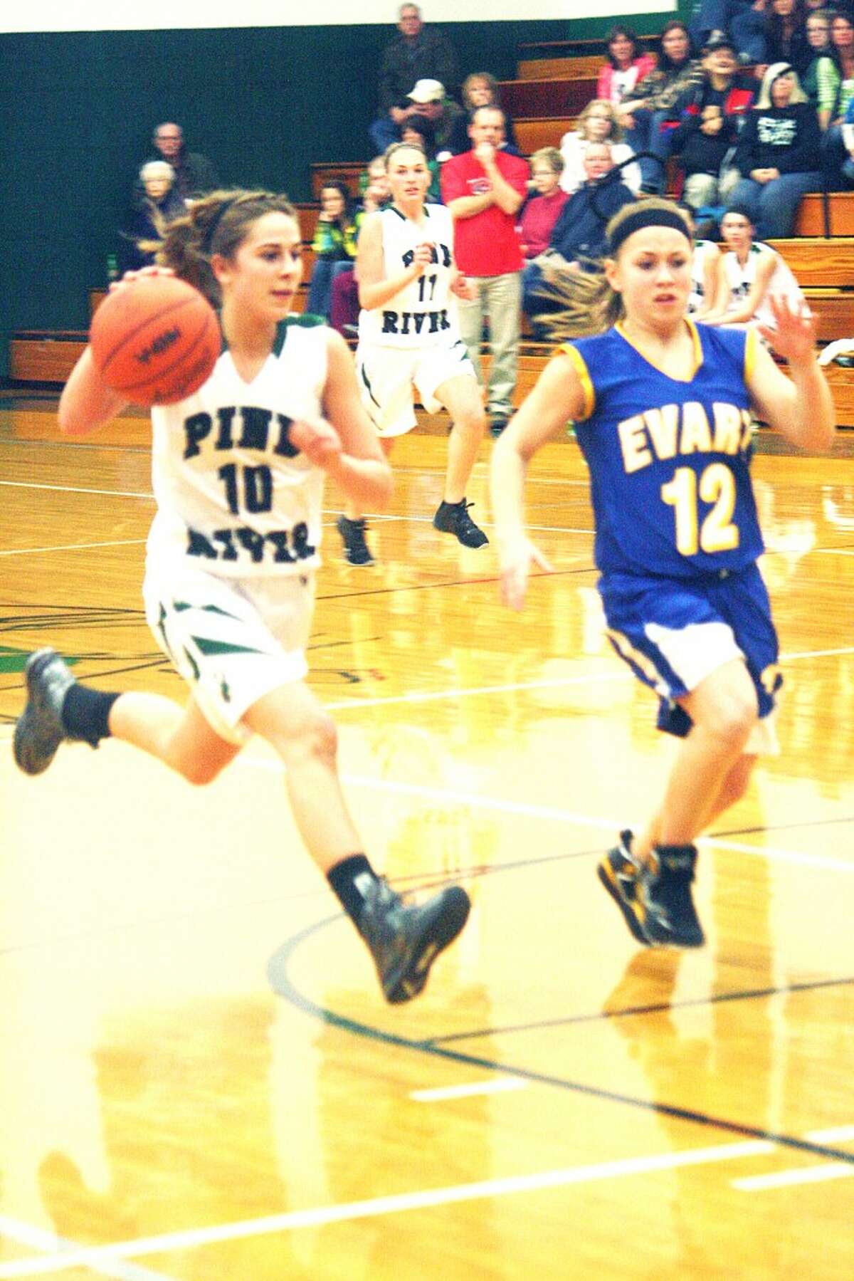 Two for Two: Kassy Nelson (10) drives past Evart’s Tabby Turley (12). (Herald Review photo/John Raffel)