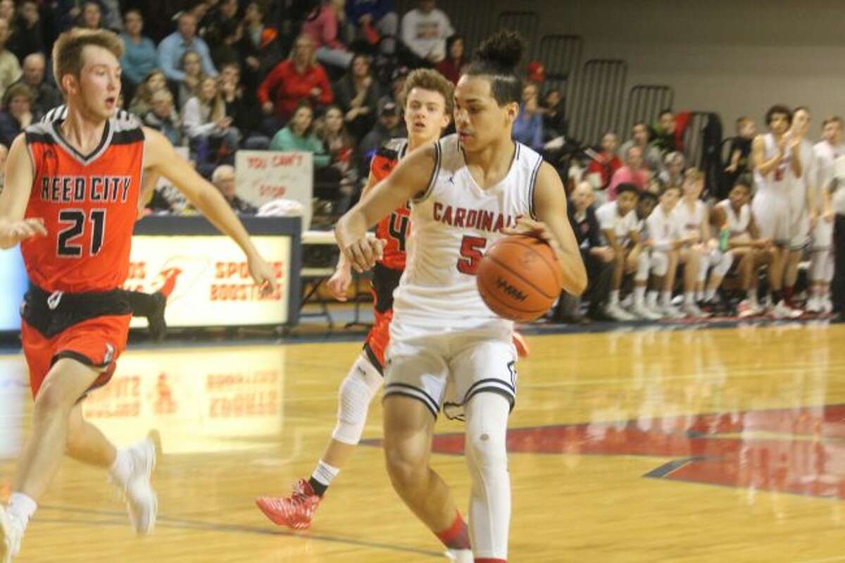 Cody Kailing (21) gets set to play defense for Reed City.