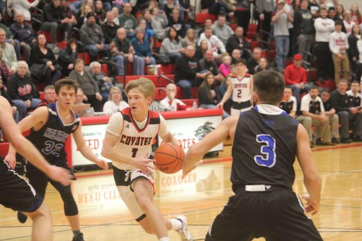 Reed CIty's Jackson Price heads to the basket.