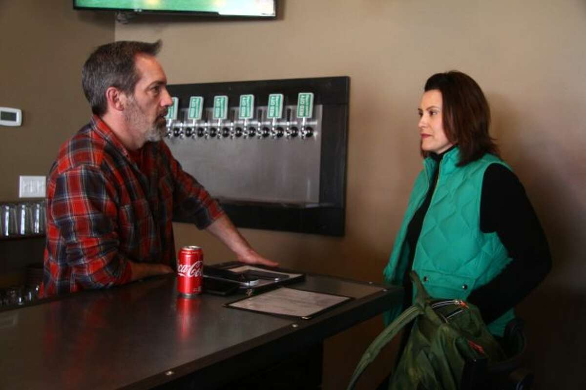 Kevin Murphy, owner of Reed City Brewing Company, chats with Gretchen Whitmer, a democratic candidate for governor of Michigan, on Sunday at the brewery. Whitmer was visiting the area as part of her campaign, talking with residents and business owners about issues they felt she should focus on. (Herald Review photos/Emily Grove)