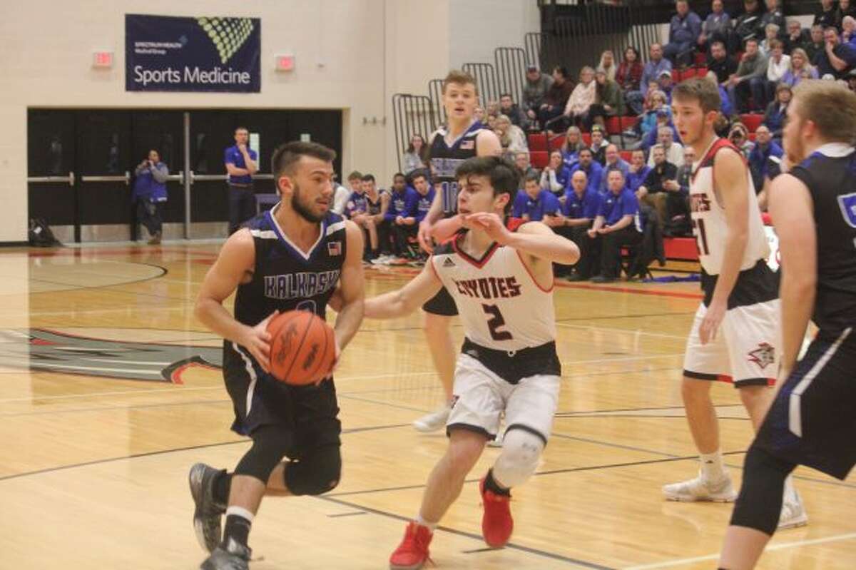Zac Saez (right) plays defense against Kalkaska.