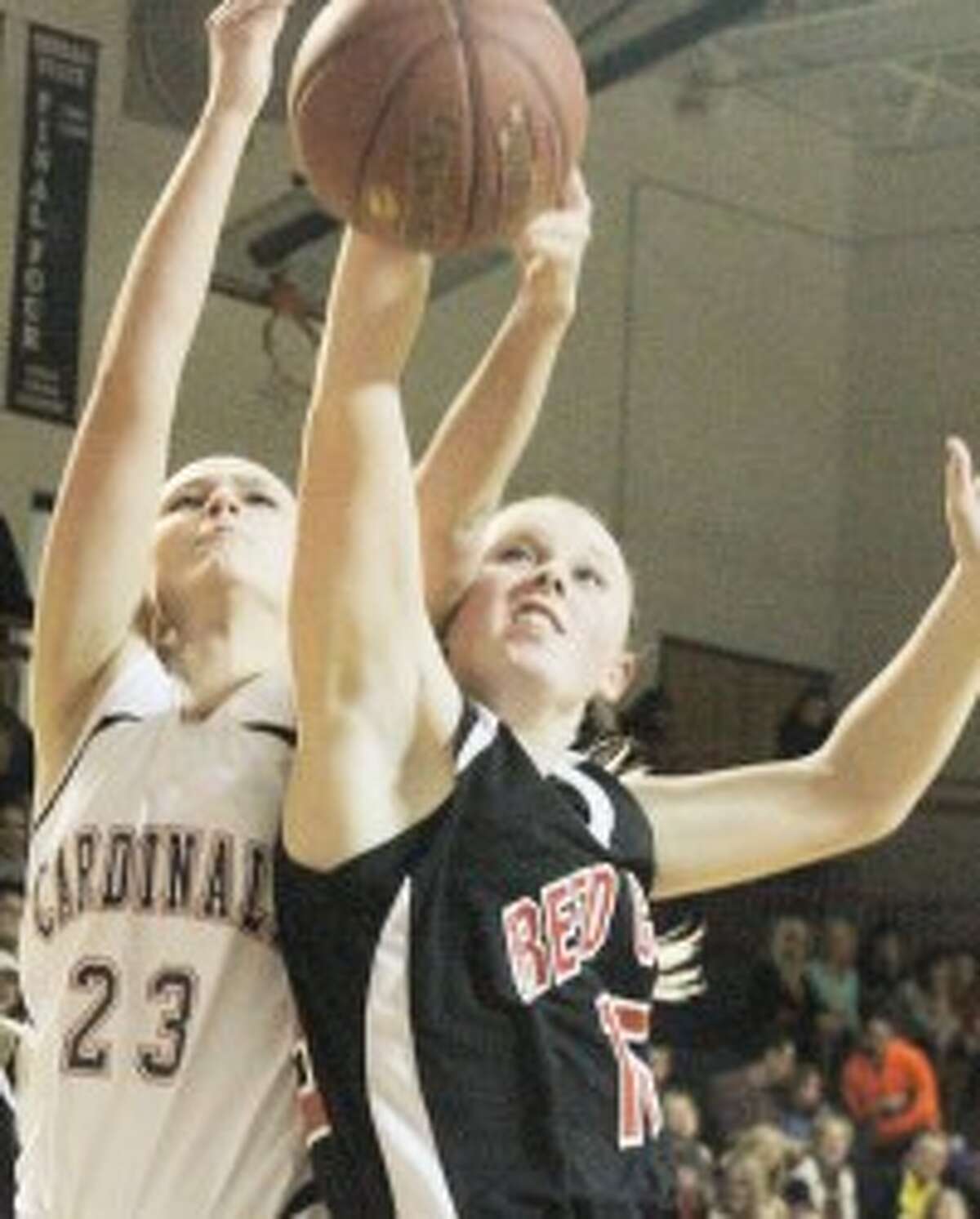 FIGHT FOR IT: Big Rapids' Sam Weaver (left) and Reed City's Makenzie Switzer battle for a rebound during Friday's high school basketball action. (Pioneer photo/Bob Allan)