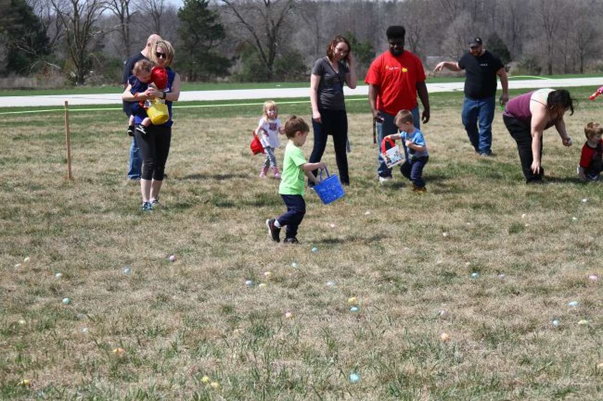 Children look for eggs during the Easter Egg Hunt last year at Roben-Hood Airport.