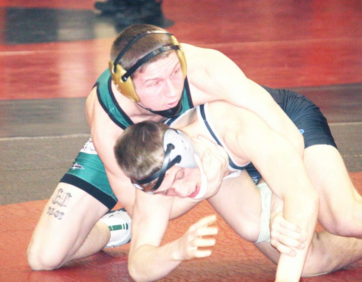 CONFERENCE: Kyle Nixon (left) of Pine River works on Tanner Kuipers of West Ottawa in Saturday's Reed City Invitational. (Herald Review photo/John Raffel)