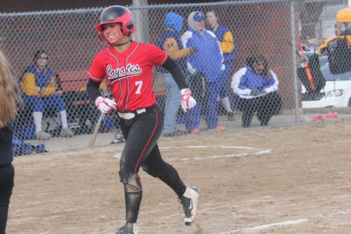 Jordyn Storch celebrates her first home run of the season against Evart.