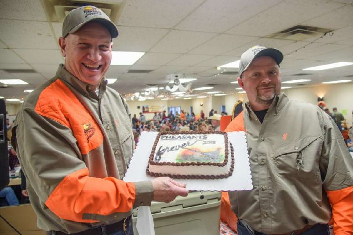 Mark Sochocki (left) and WIllie Holmes get ready to auction off various items