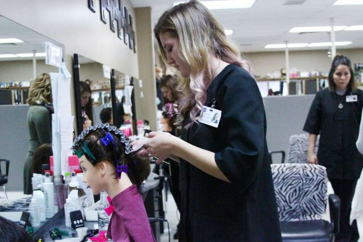 Mecosta-Osceola Career Center students practice on models while working in the school's salon. MOCC recently was granted accreditation for their cosmetology program, which may help students afford their courses if they return for their 13th year of study. (Herald Review file photo)
