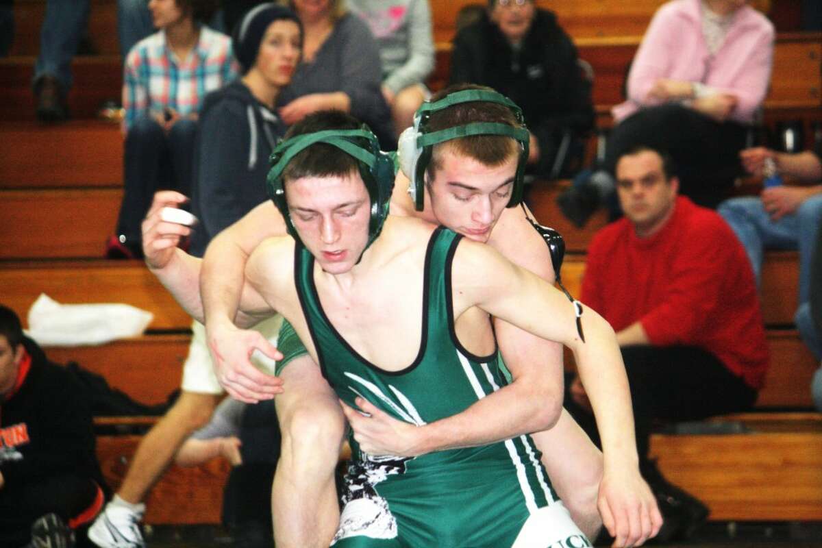 TITLE WINNERS: Pine River’s Darwin Dean (front) tries to get away from Matthew Elliott of Forest Area during the 125-pound title match in the Mid-Michigan Wrestling Conference tournament on Saturday at Pine River. (Herald Review/John Raffel)