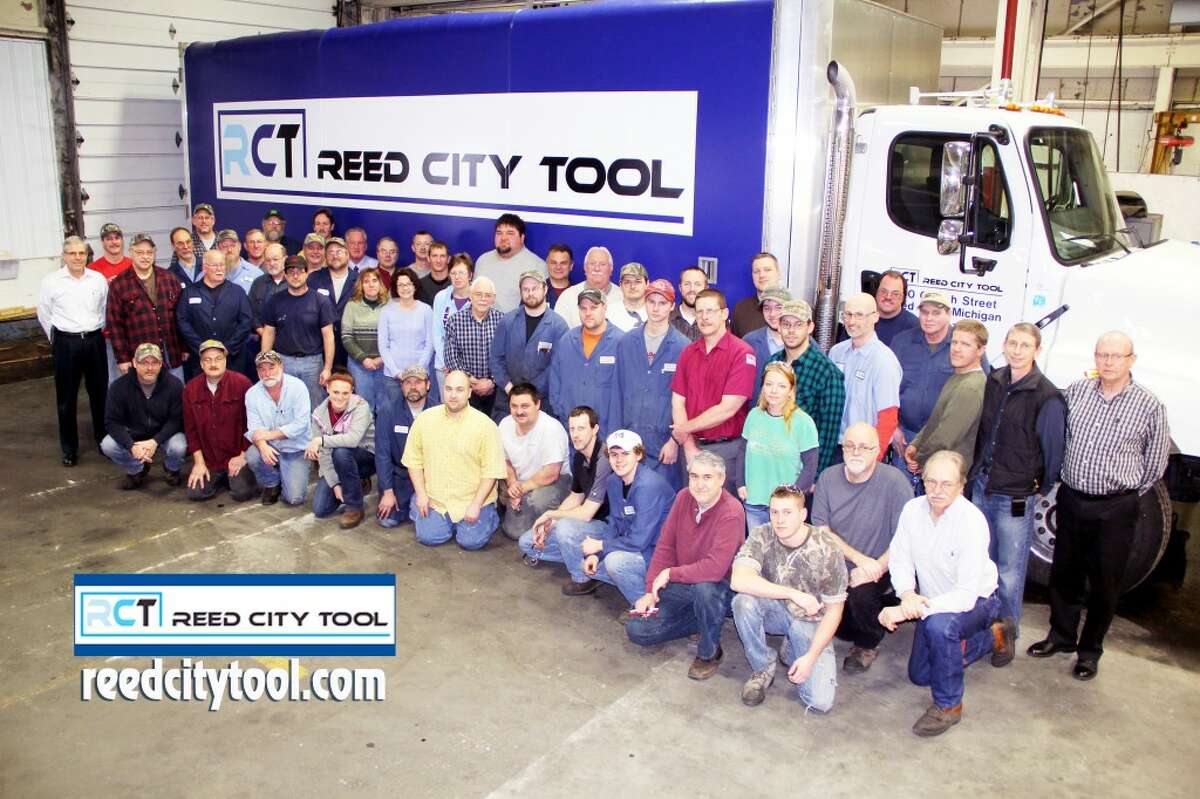 EXPANSION: Reed City Tool employees pose near a brand new truck the company recently purchased to deliver its manufactured product. The company's steady increase in business has created 30 jobs in the past three years. (Courtesy photo/DW Video & Multimedia, LLC c2013)