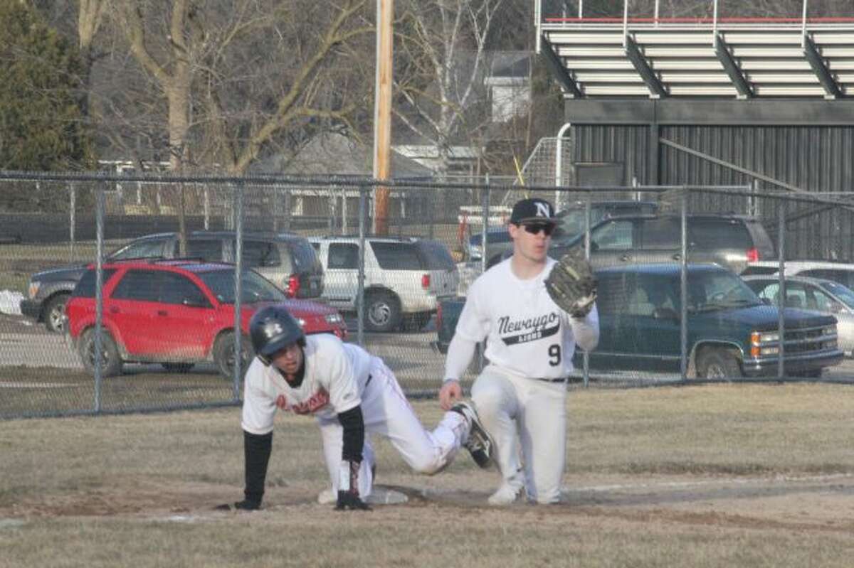 Reed City's Hunter Morrison is tagged out at third base.
