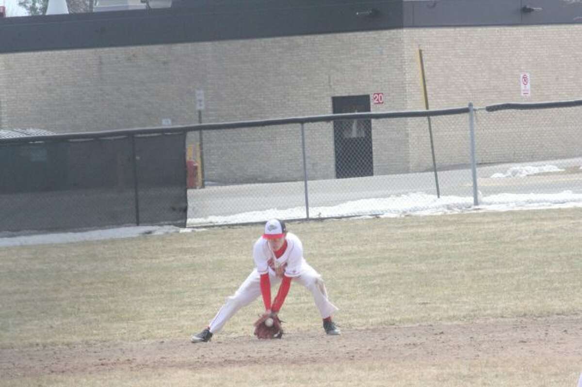 Brandon Wirth scoops up a ground ball against Evart;